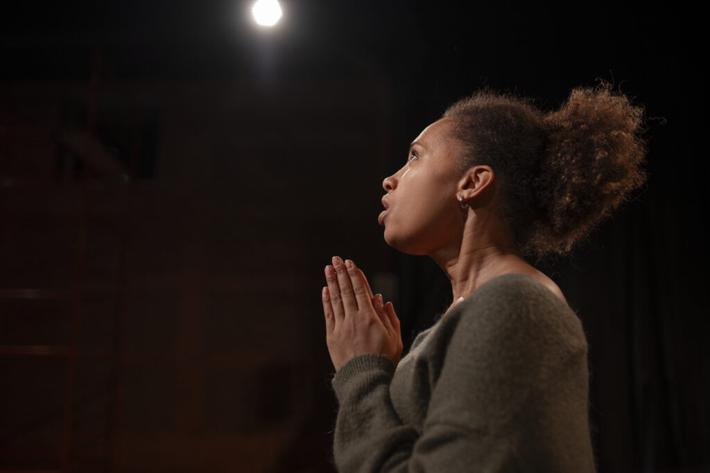 Husband or wife praying alone for their marriage, seeking strength and peace.