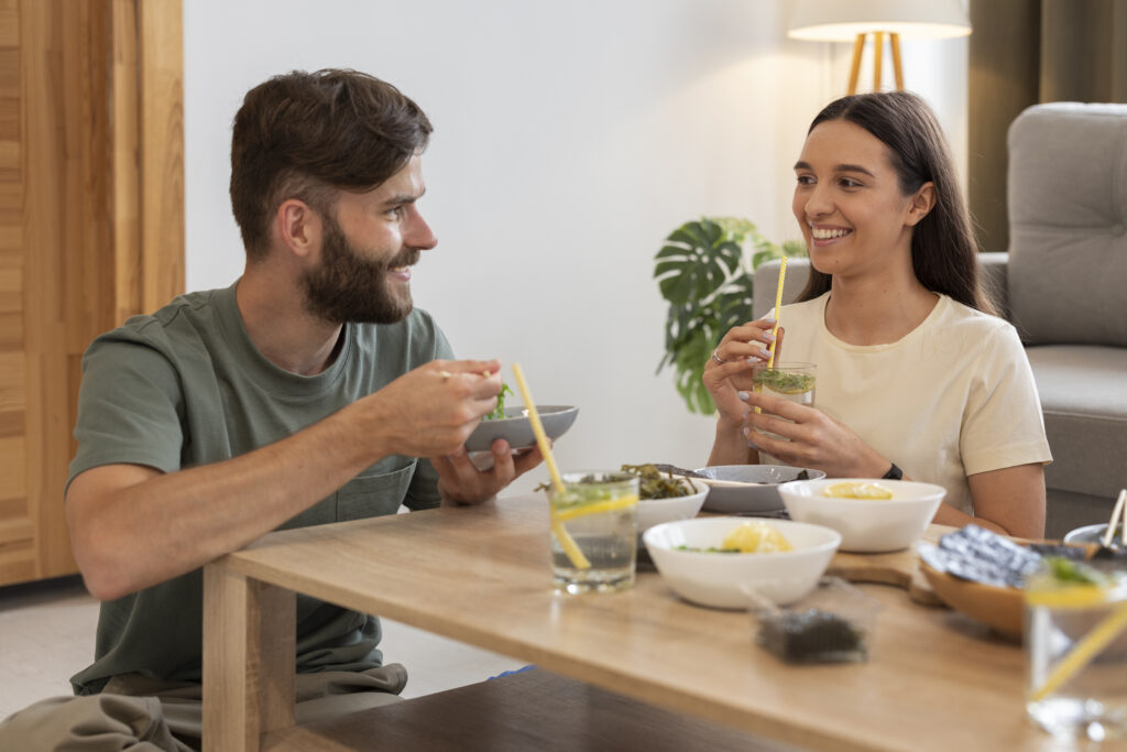 Deeply connected married couple smiling across the table, enjoying a moment of appreciation.