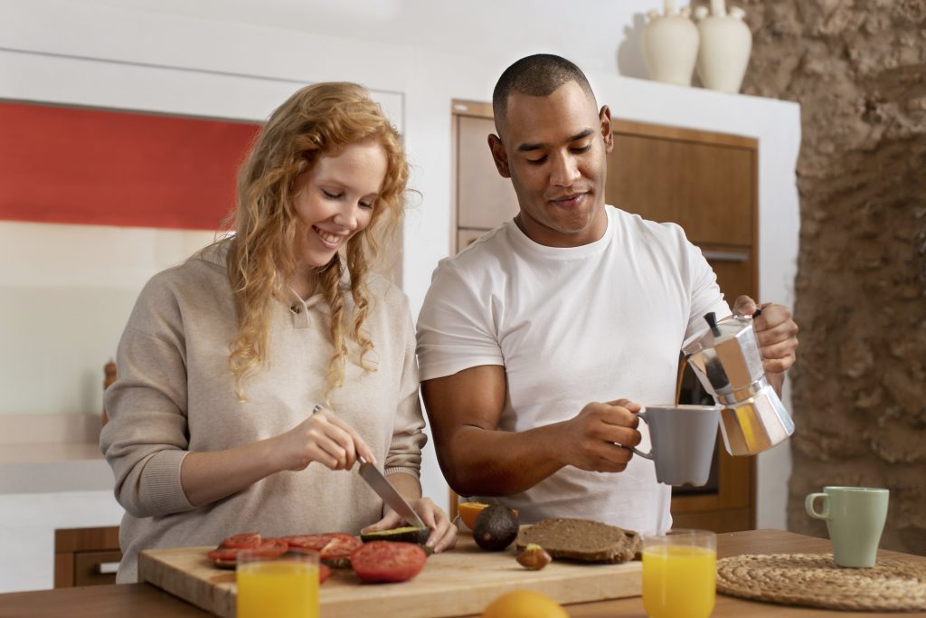 Married couple sharing kitchen tasks, showing how different strengths support the relationship.